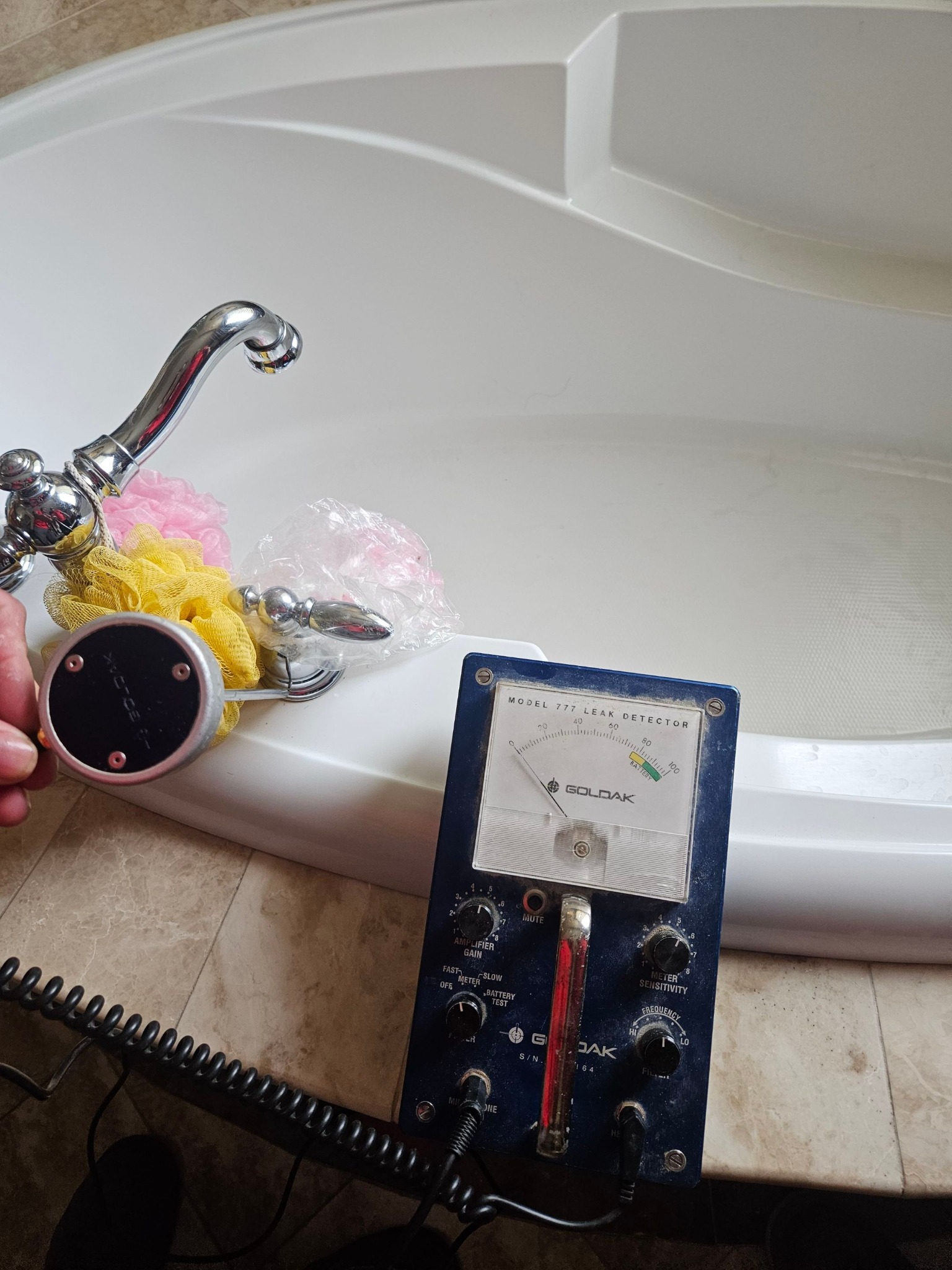 Leak detection equipment being used at a bathtub